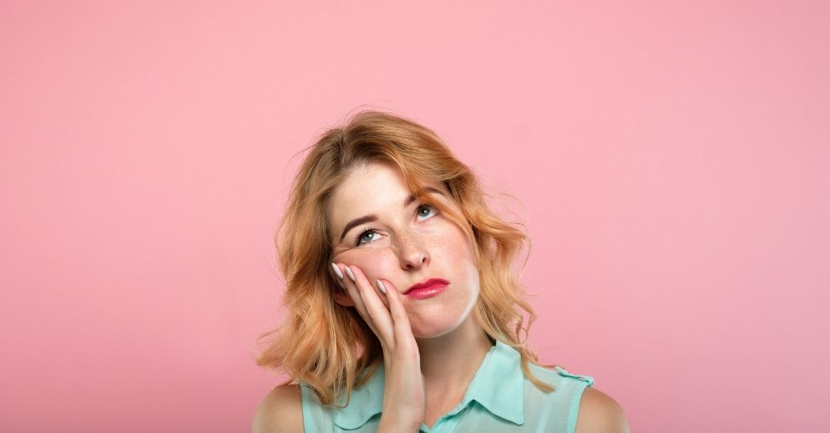 Woman resting head on hand