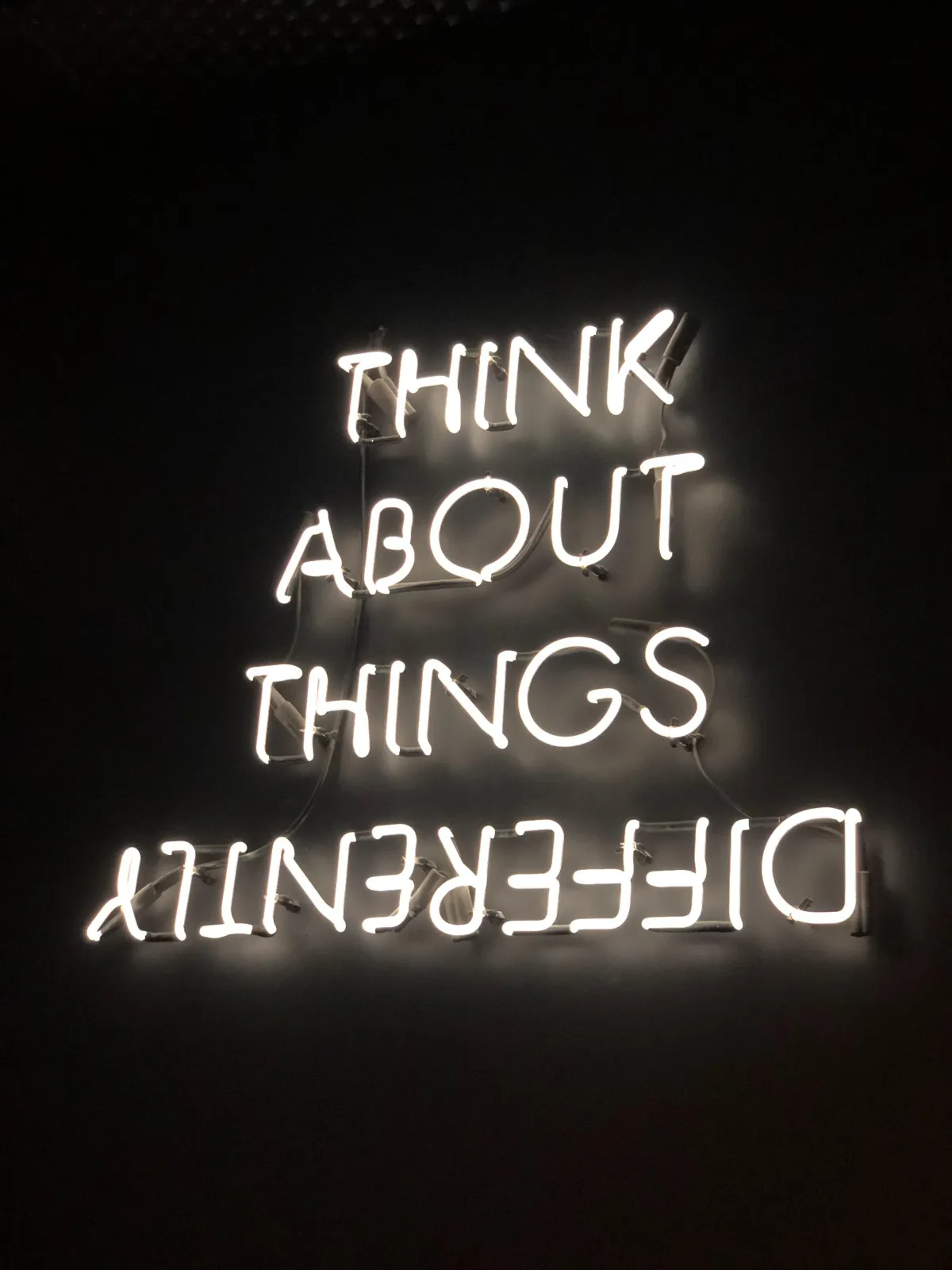 Neon sign about thinking differently, tied to property mindset shift