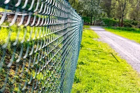 Chain link fence installation along property line by Brownsville Fence Contractors