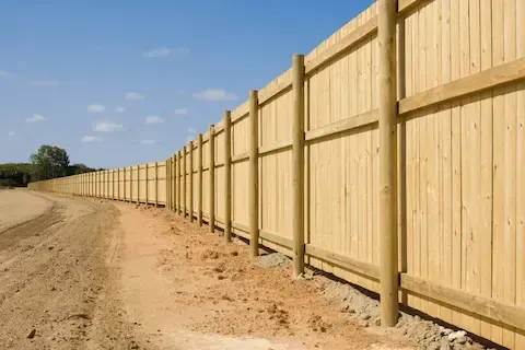Wood fence installation along property line by Brownsville Fence Contractors