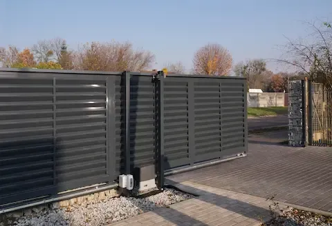 Automatic metal driveway gate installed by Brownsville Fence Contractors