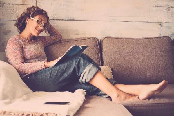 Lady reading on a sofa