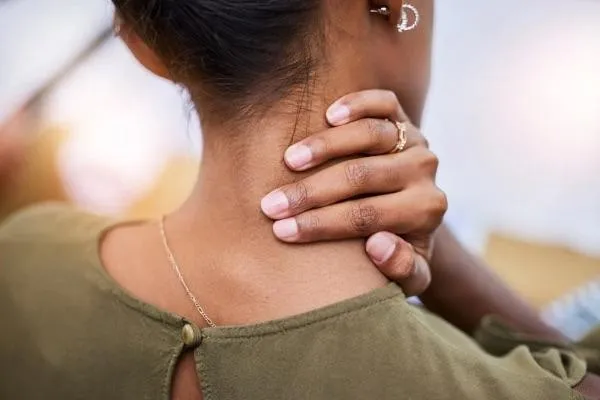 Image of a lady holding her neck.