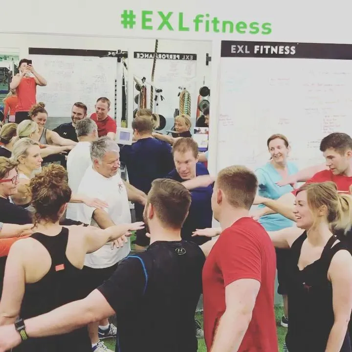 people at the gym smiling, encouraging, and supporting each other during workouts, representing gratitude and teamwork in health and fitness journeys