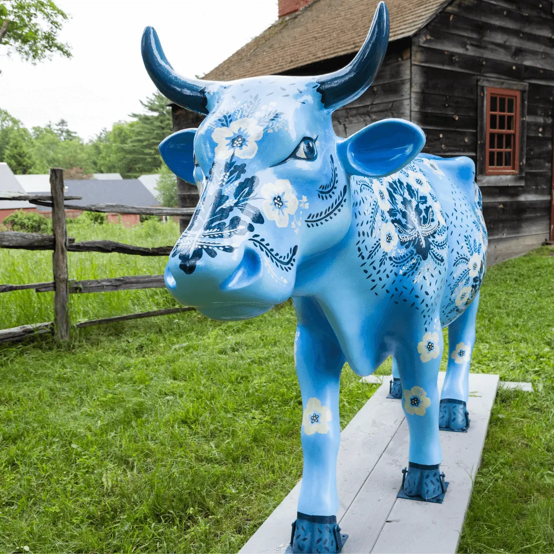 A cow sculpture painted with floral medallion wallpaper design
