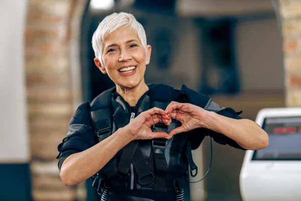 smiling senior woman doing ems training in the fitness studio
