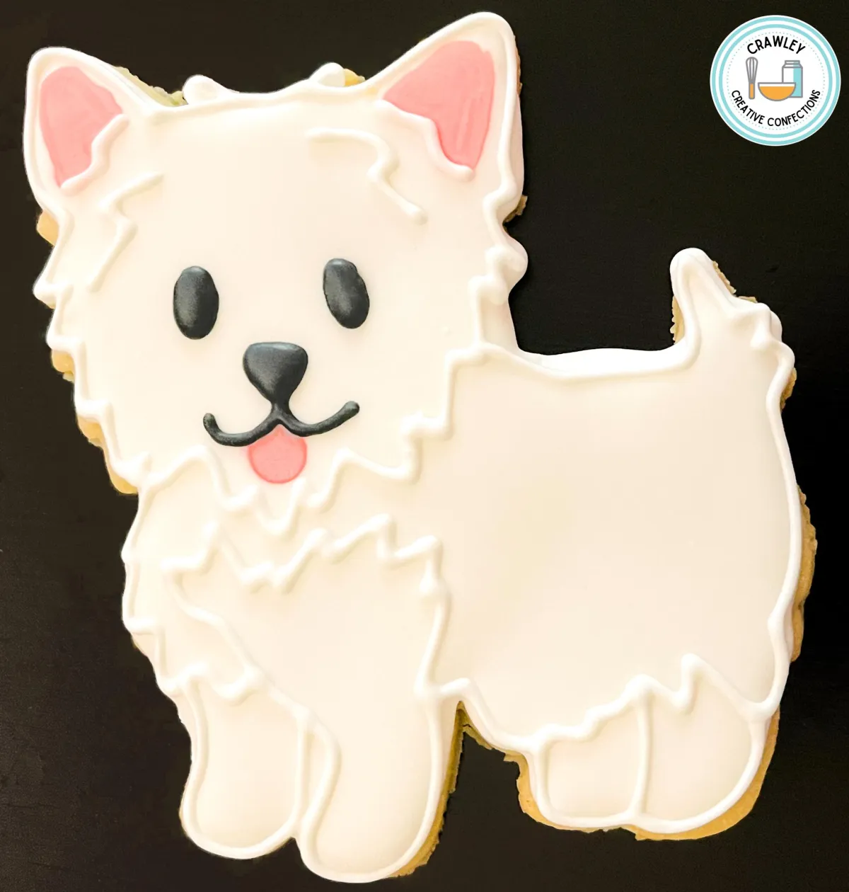 A cute collection of sugar cookies shaped like white Maltese puppies, each decorated with hand-iced details to showcase their fluffy fur and adorable features. The designs include sweet black eyes, tiny noses, and some with colorful bows or collars, perfectly capturing the charm of this lovable breed.