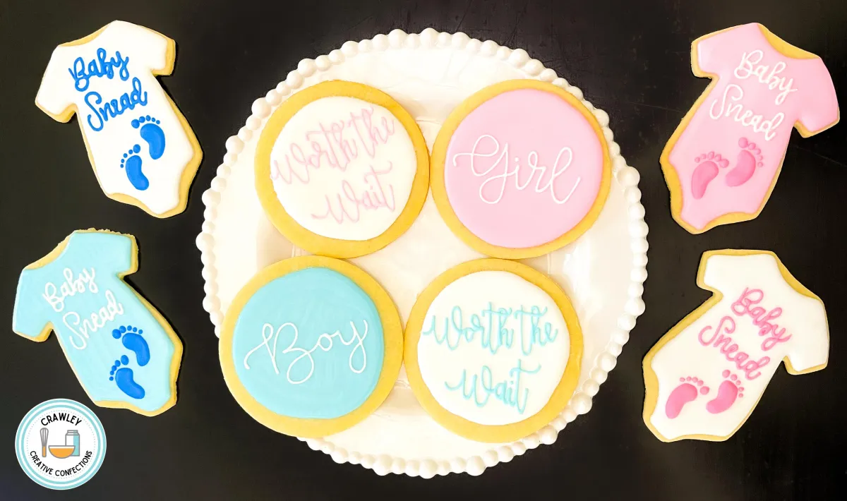 A heartfelt set of sugar cookies for a “Worth the Wait” gender reveal, decorated in soft blues and pinks. The designs include onesies with tiny baby feet and elegant hand-iced lettering, creating a sweet and meaningful celebration of anticipation and joy.