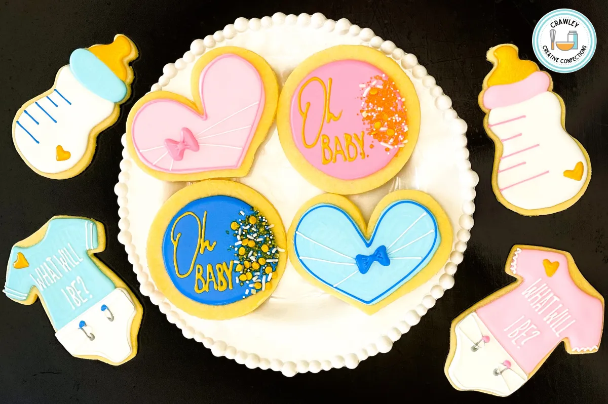 A sweet and elegant set of sugar cookies for a gender reveal party, featuring simple pink and blue hearts. Some hearts are adorned with delicate bows, creating a charming and minimalist design. Each cookie is hand-iced with soft colors and clean details, perfect for celebrating the big reveal.