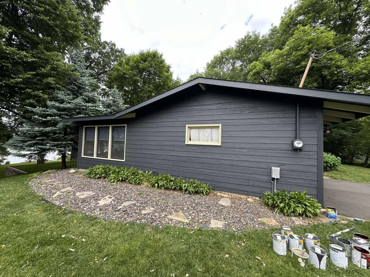 Freshly painted dark blue house exterior with white trim and modern styling