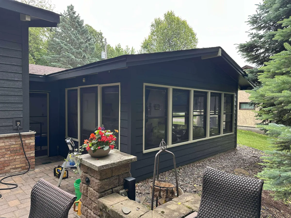 Newly painted blue house exterior with white trim, showcasing modern siding and fresh curb appeal