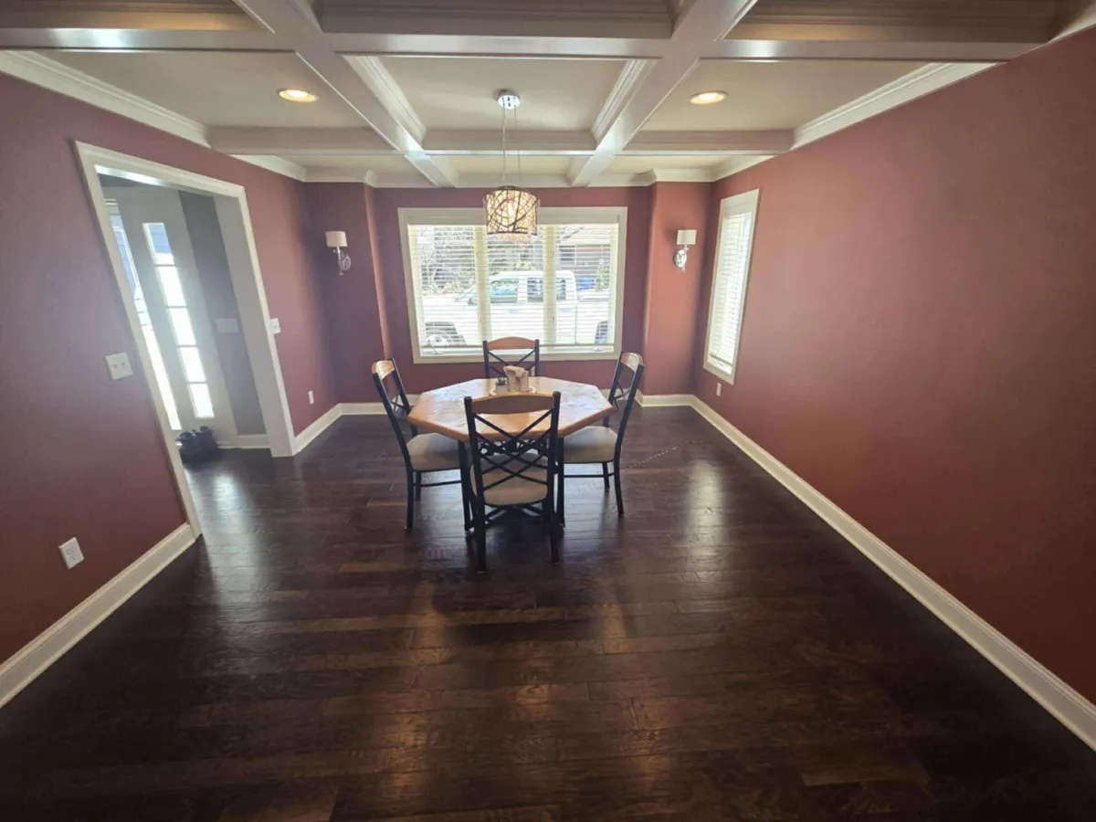 Dining room with scuffed walls and ceiling before repainting