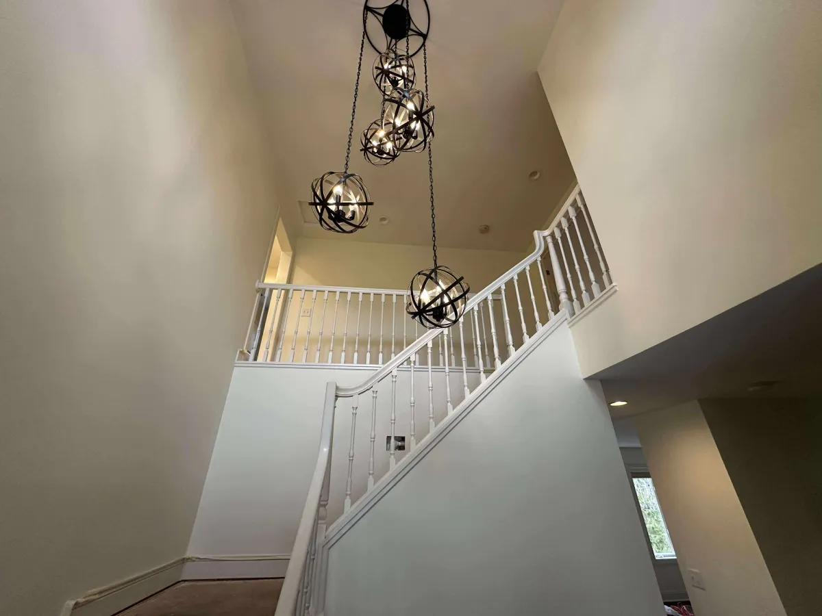 Interior stairwell with worn walls and trim before repainting