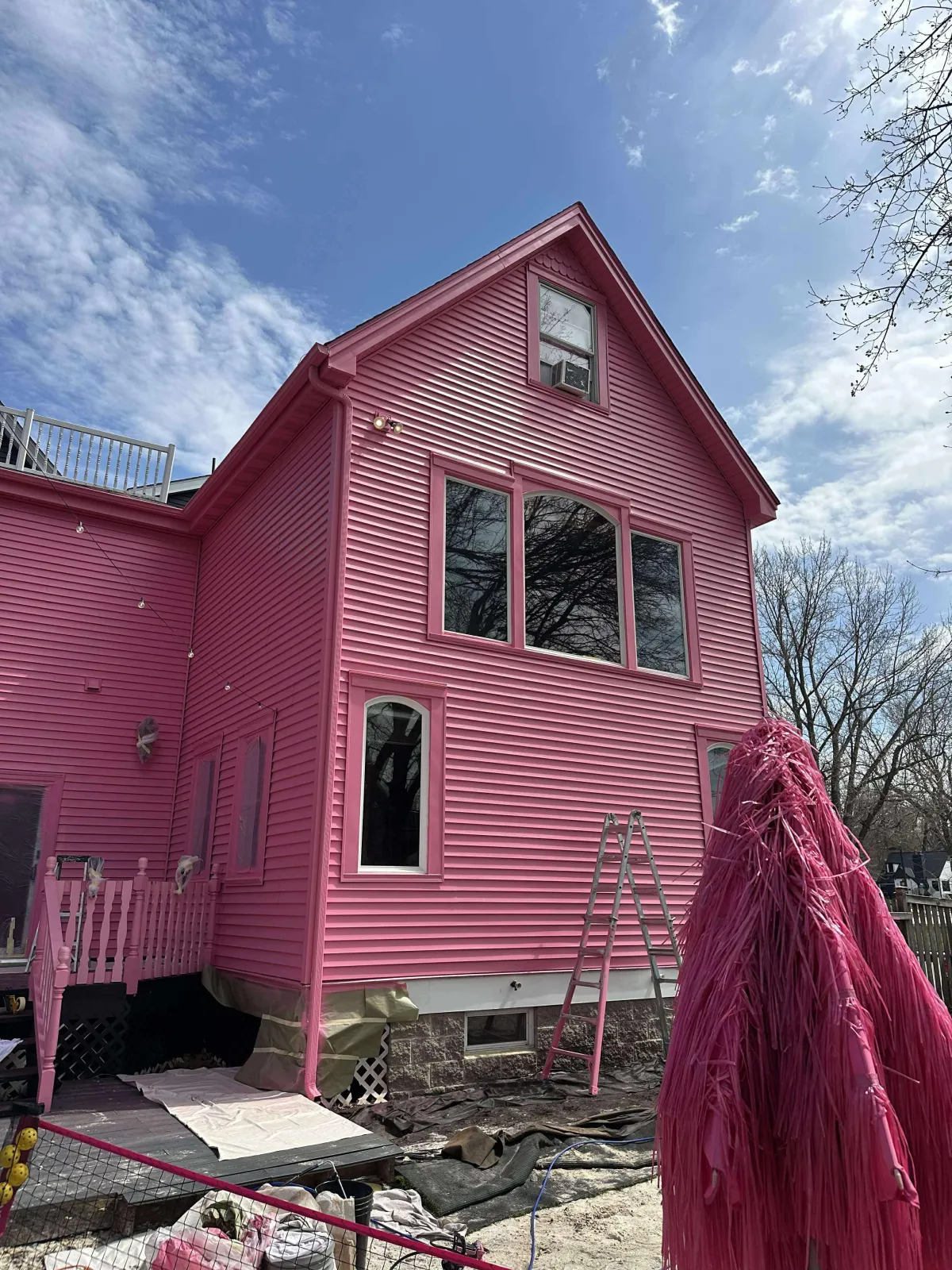 Freshly painted pink exterior of the Fleetwood Rentals home in Hudson, WI with white trim