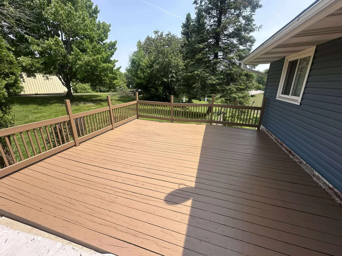 Refinished backyard deck with rich wood tone after professional restoration