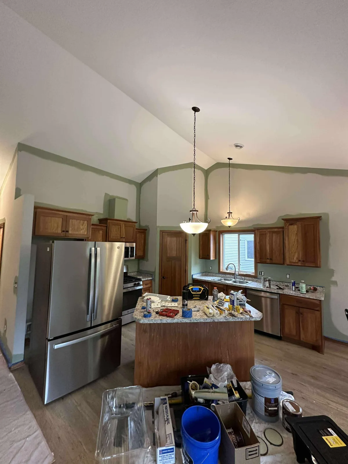 Kitchen with worn and dated wall paint before interior repaint