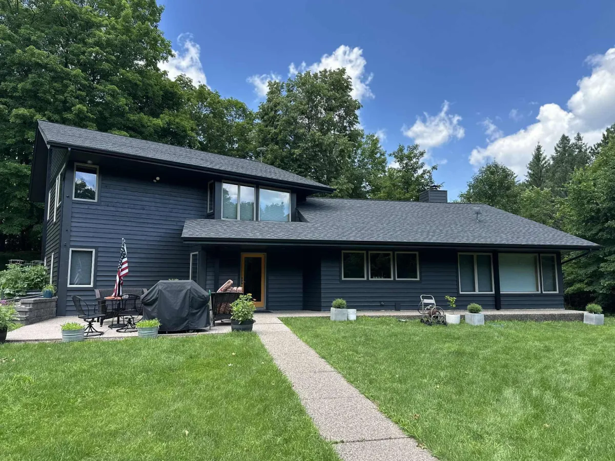 House exterior painted in dark gray with black trim and accent
