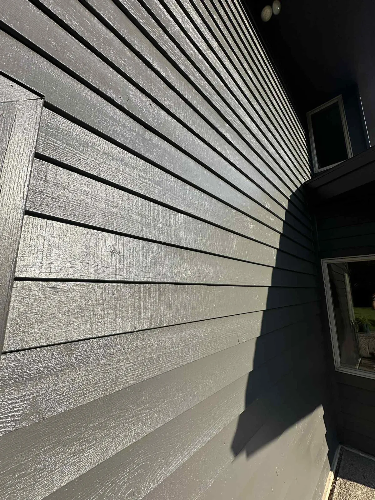 Close-up of dark gray exterior with black trim showing clean lines and smooth paint finish