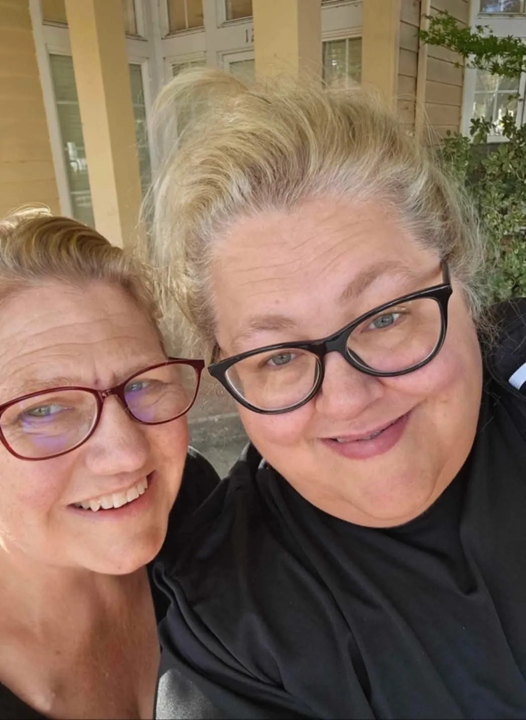 Char and Sandie, co-founders of Live Sapphire, smiling together outdoors—radiating warmth, joy, and connection.