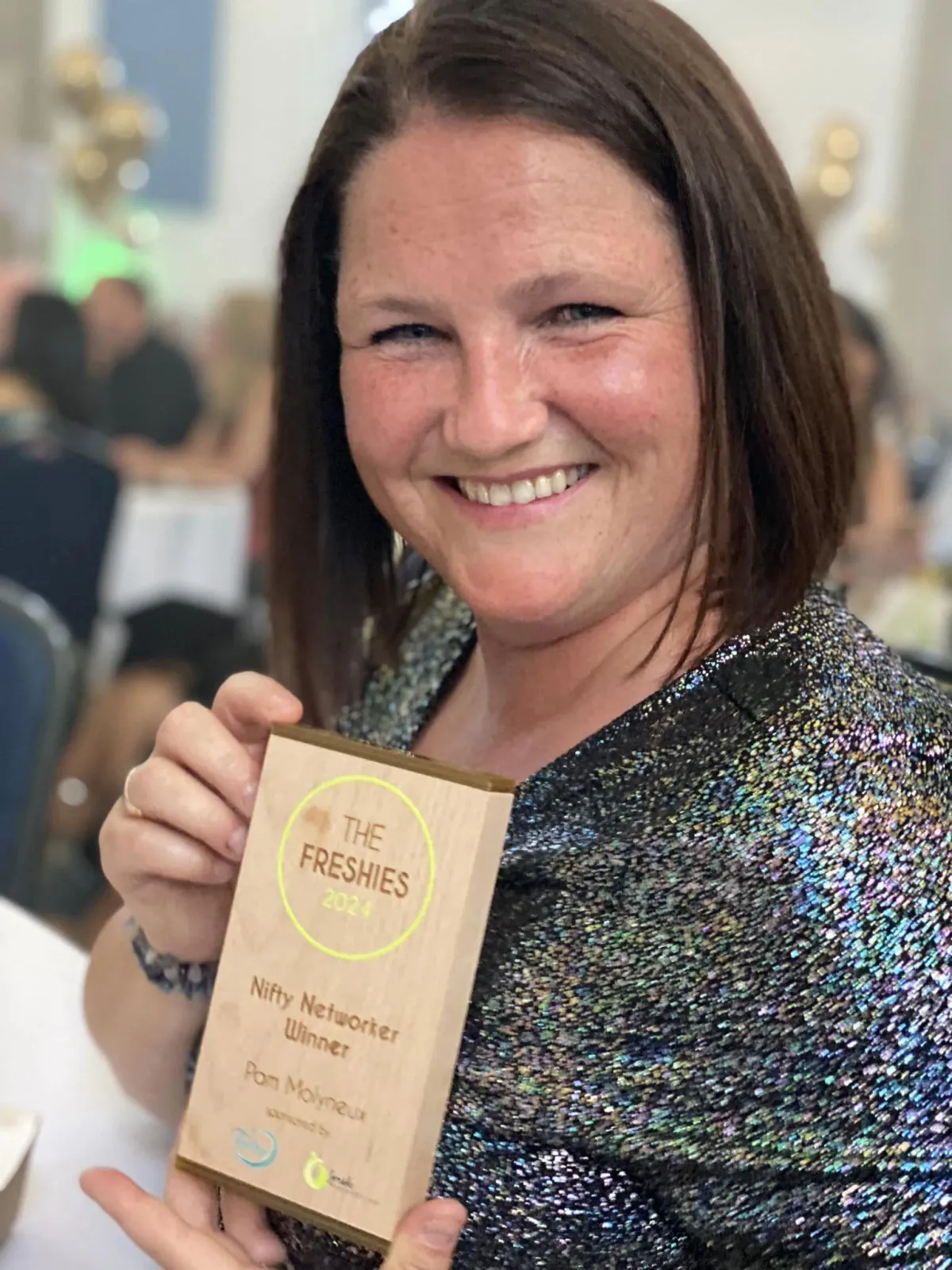 A photo of Pam Molyneux holding her Nifty Networker Freshies Award