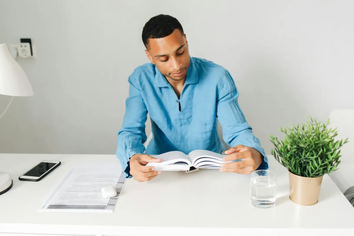 Minimalist journal and pen on a wooden desk representing a daily habit routine