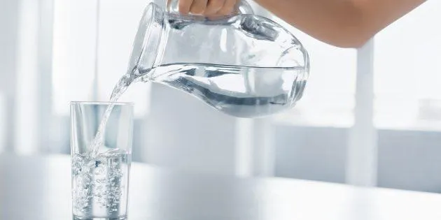 Water jug pouring into a glass.