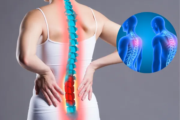 Pain in the spine, woman with backache on gray background, back injury