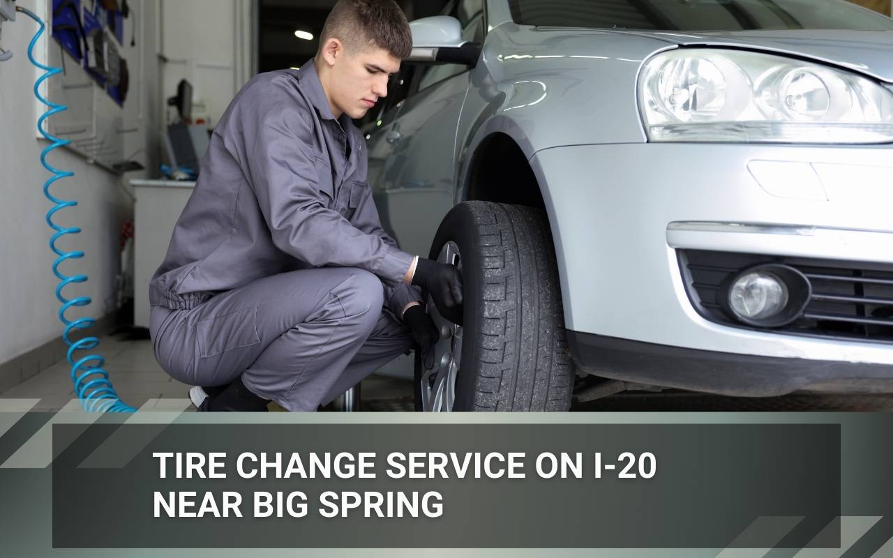 Driver receiving Tire Change Service on I-20 near Big Spring from a roadside technician on the highway shoulder
