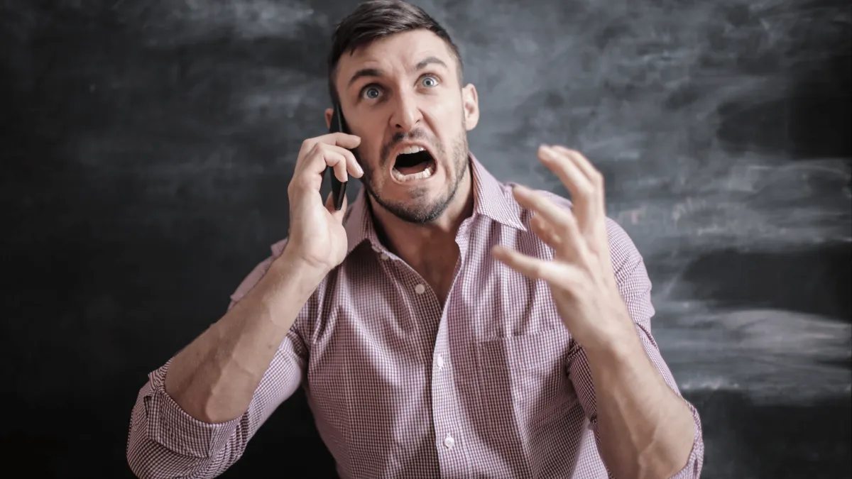 Man in Pink Dress Shirt in Distress