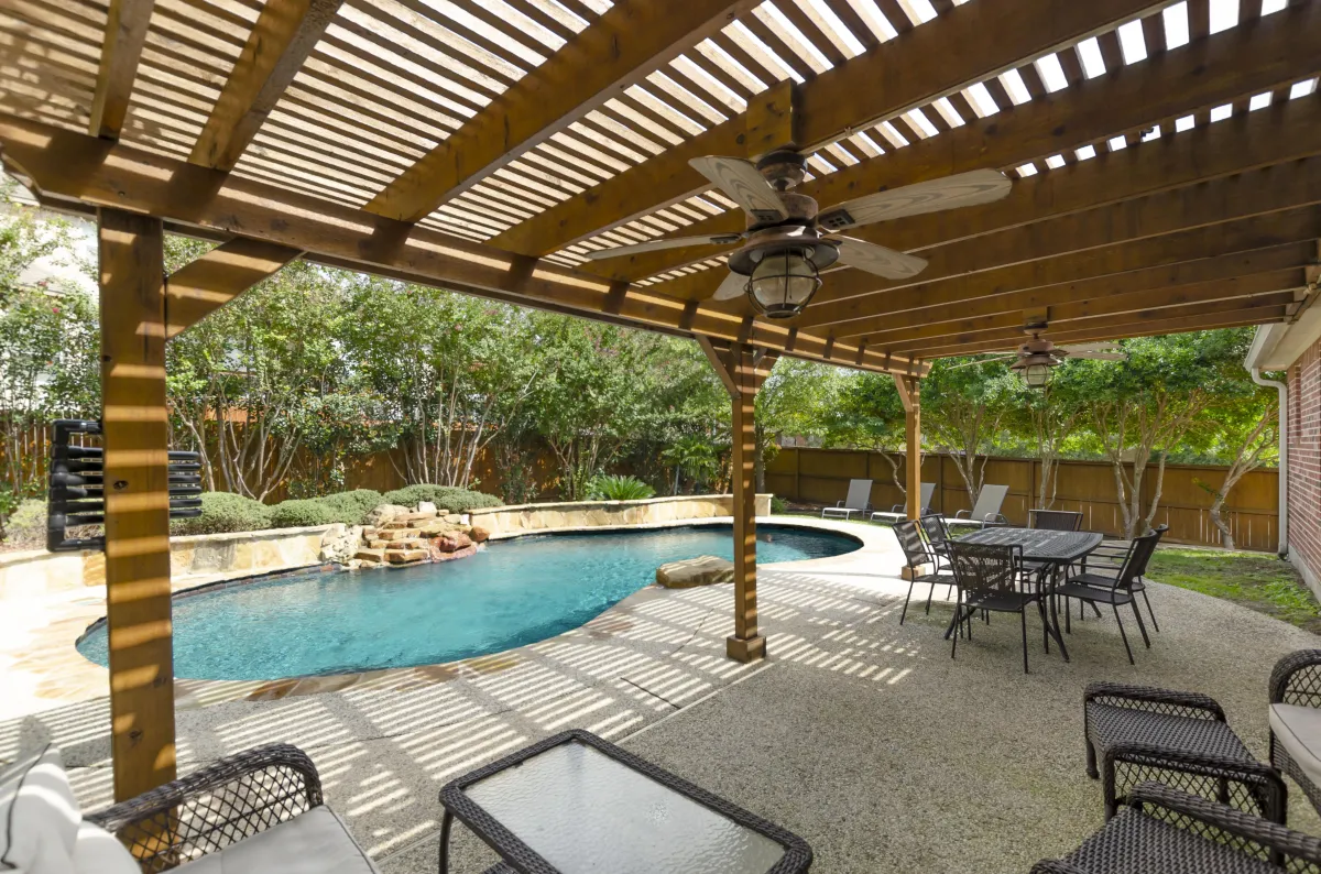 Inviting backyard pool and clean patio prepped for spring real estate photos and curb appeal staging