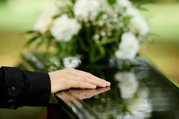 hand on a coffin