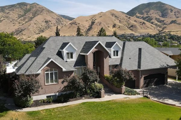 Luxury custom home in Alpine Utah with new architectural asphalt shingle roof and Wasatch Mountain views