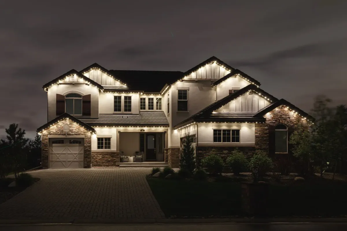 Permanent warm white exterior lighting system installed on luxury home in Alpine Utah highlighting rooflines and architectural details