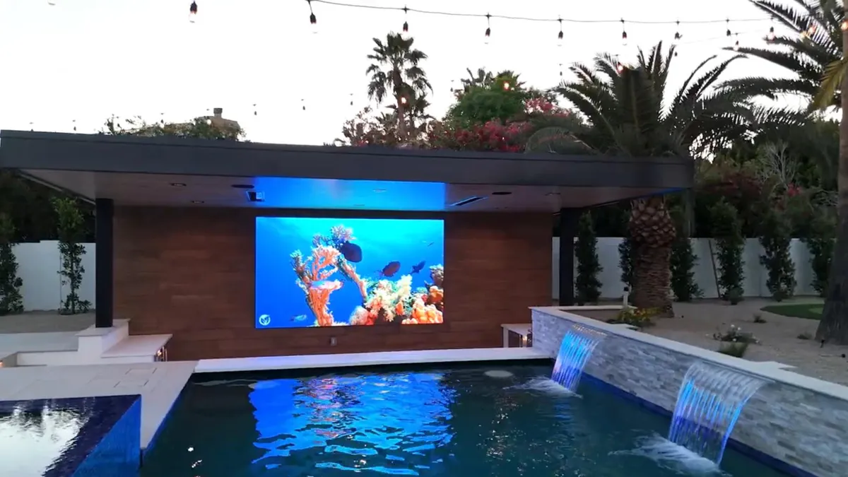 YOLO outdoor TV installed on a North Dallas patio, visible and bright in direct afternoon sun