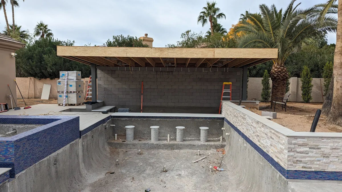 Large-format YOLO LED display integrated into a luxury outdoor poolside environment