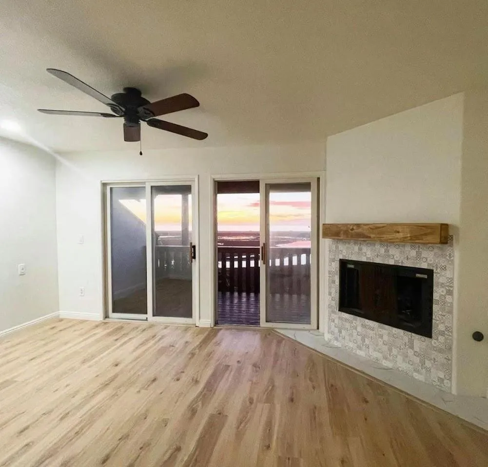 Close-up of hardwood flooring in a modern living room with natural lighting.