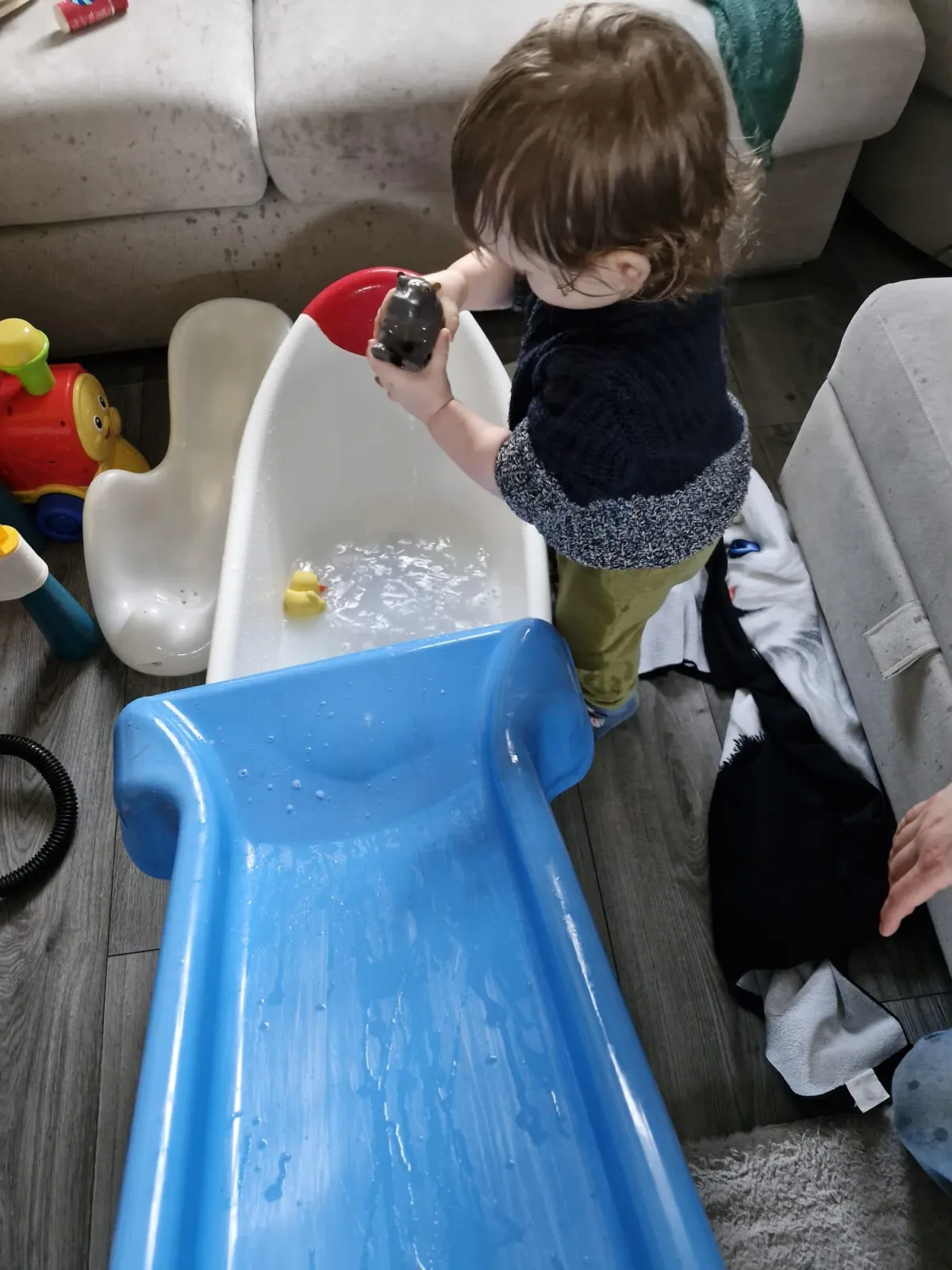 Toddler holding a toy hippo