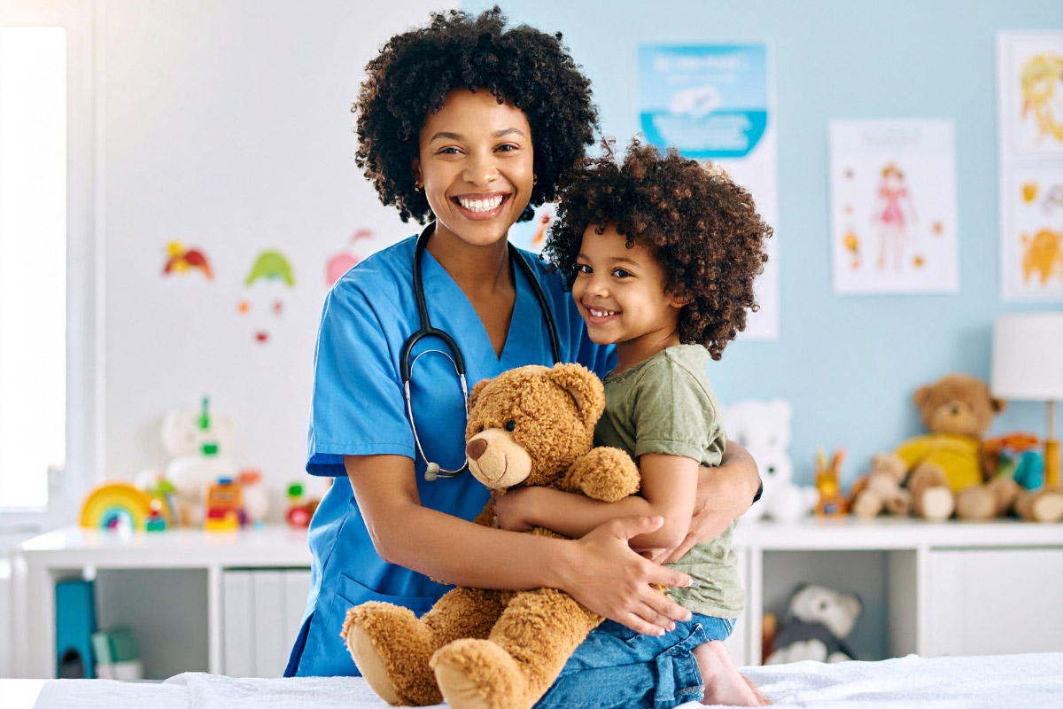 Pediatric clinician smiling with a child in a friendly exam room, emphasizing supportive prosthetic care