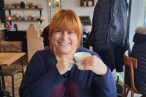 emilie forster holding a cup