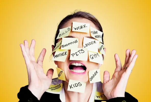 Stressed, overwhelmed woman with ‘to do’ post it notes covering her face