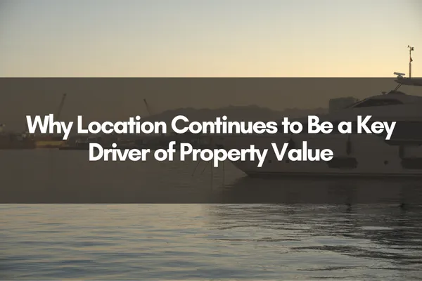 "Cover image with the title 'Why Location Continues to Be a Key Driver of Property Value' over a calm waterfront scene at sunset with boats and a distant city skyline."