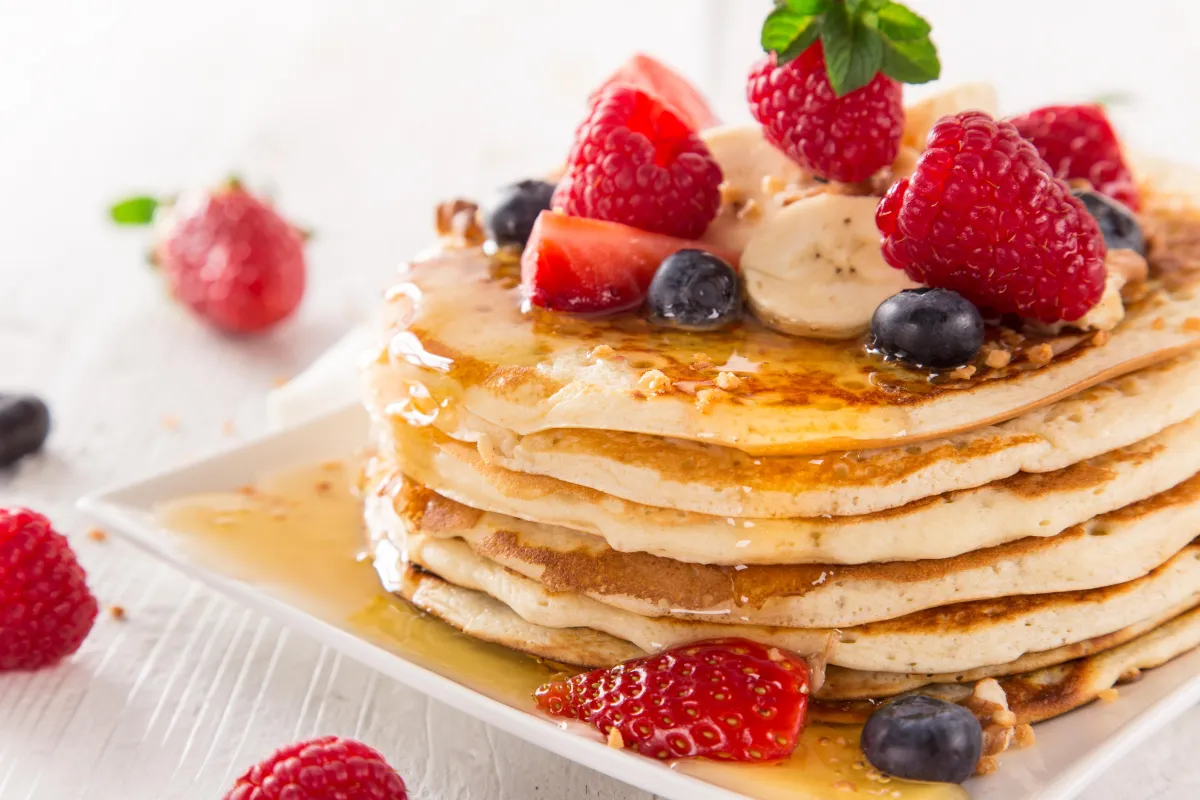 Stack of Pancakes with fruit and syrup
