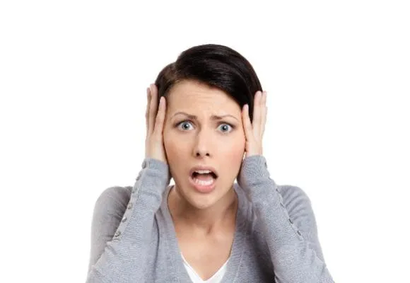 confused woman with hands on head