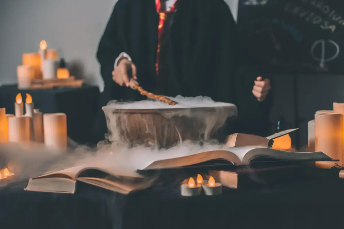 Harry potter student with wand infront of cauldron