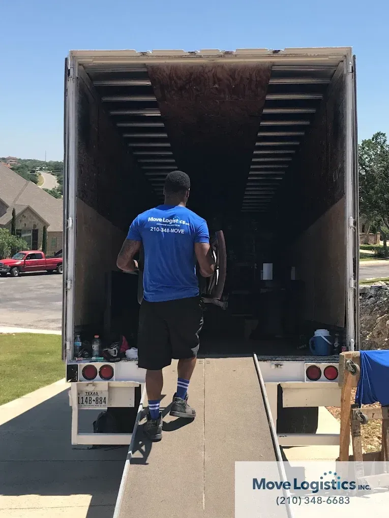 one of Move Logistics's crew member carefully loading items into the truck