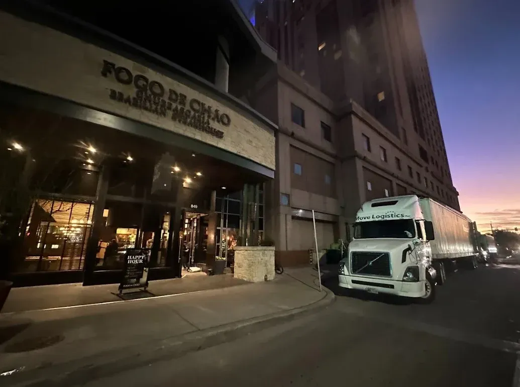 Move Logistics's truck in front of a building