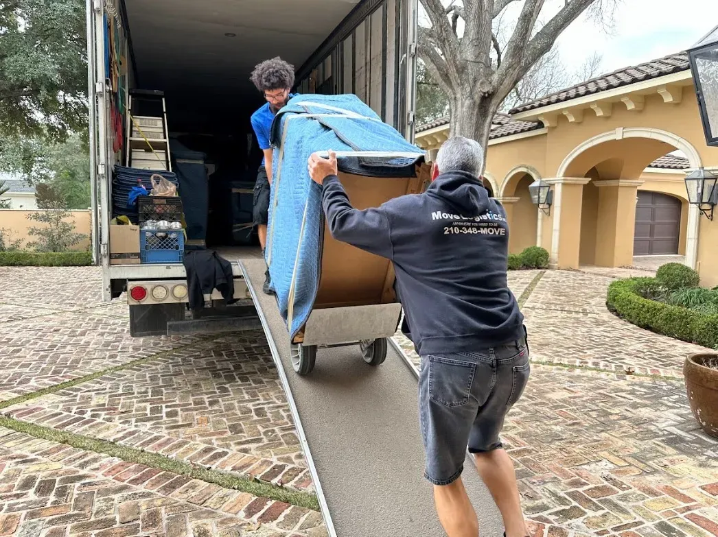 Move Logistics crew members safely loading items into the truck
