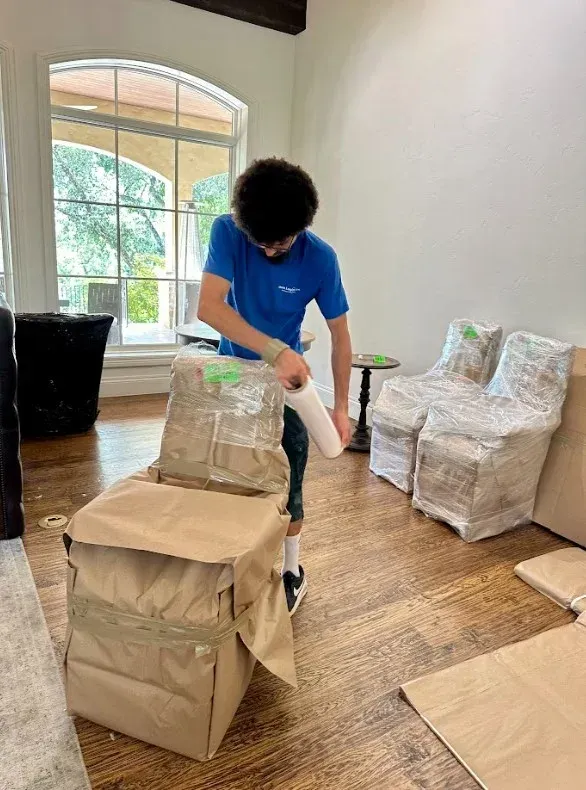 a Move Logistics's crew member carefully prepairing items for moving