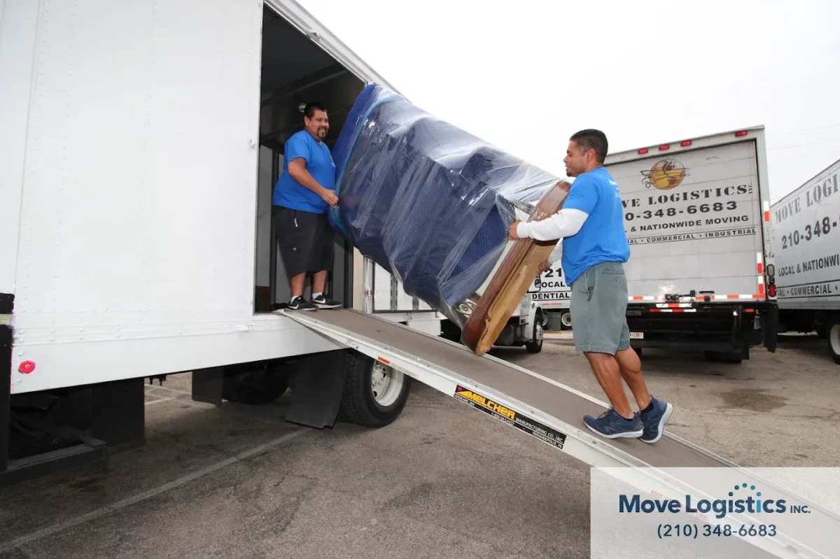 Move Logistics crew members safely loading items into the truck