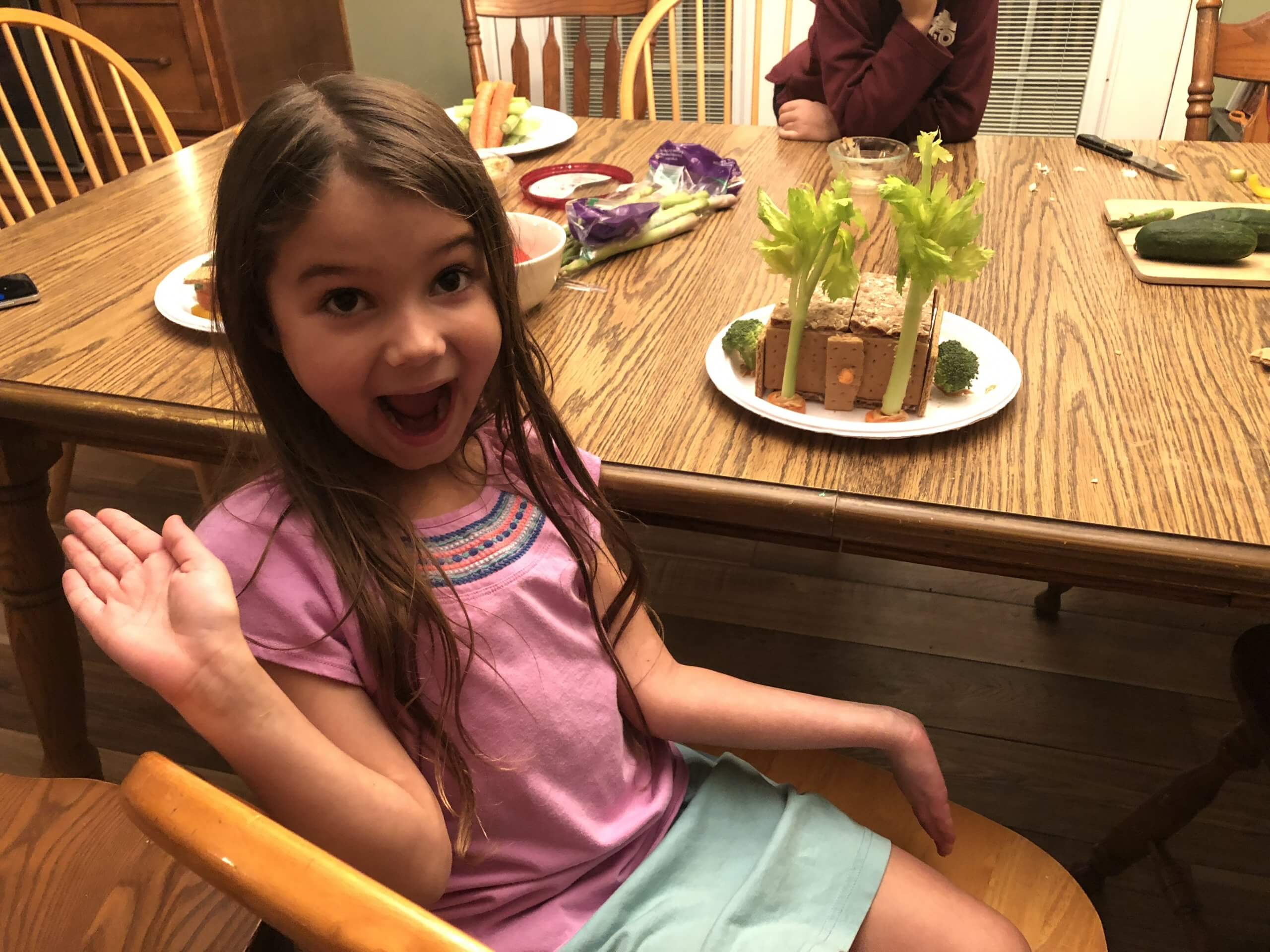 girl with health gingerbread house